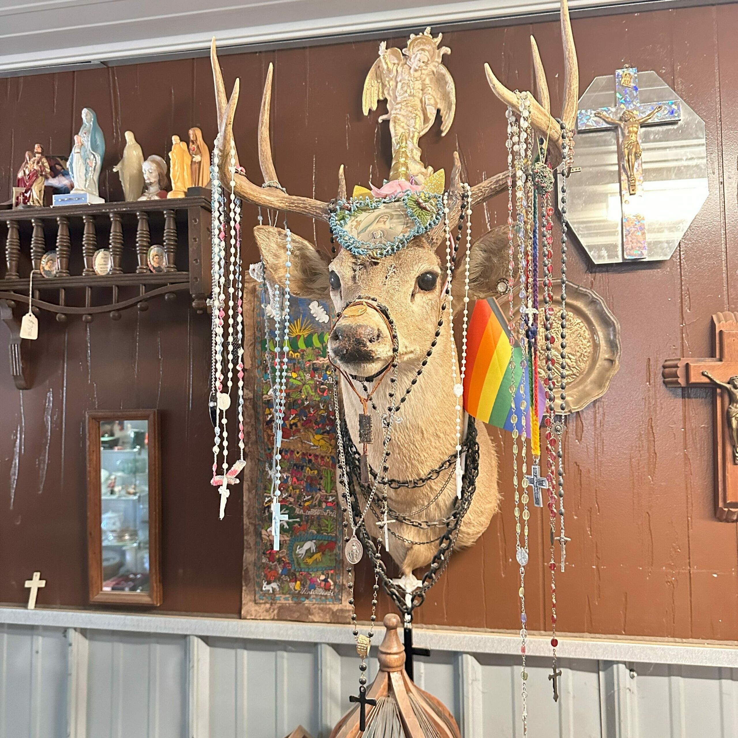 A deer mount decorated in Catholic rosaries